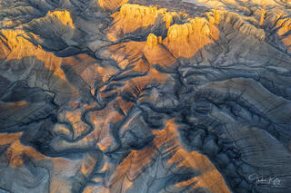 Sunrise illuminates towering buttes and mesas in the Utah badlands.