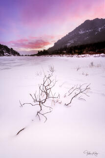 A winter landscape scene of a snow covered lake in a national park