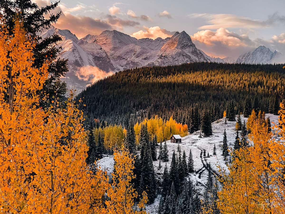 Autumn Welcomes Winter A rustic cabin in the Colorado mountains during the autumn season is enhanced by a dusting of snow.