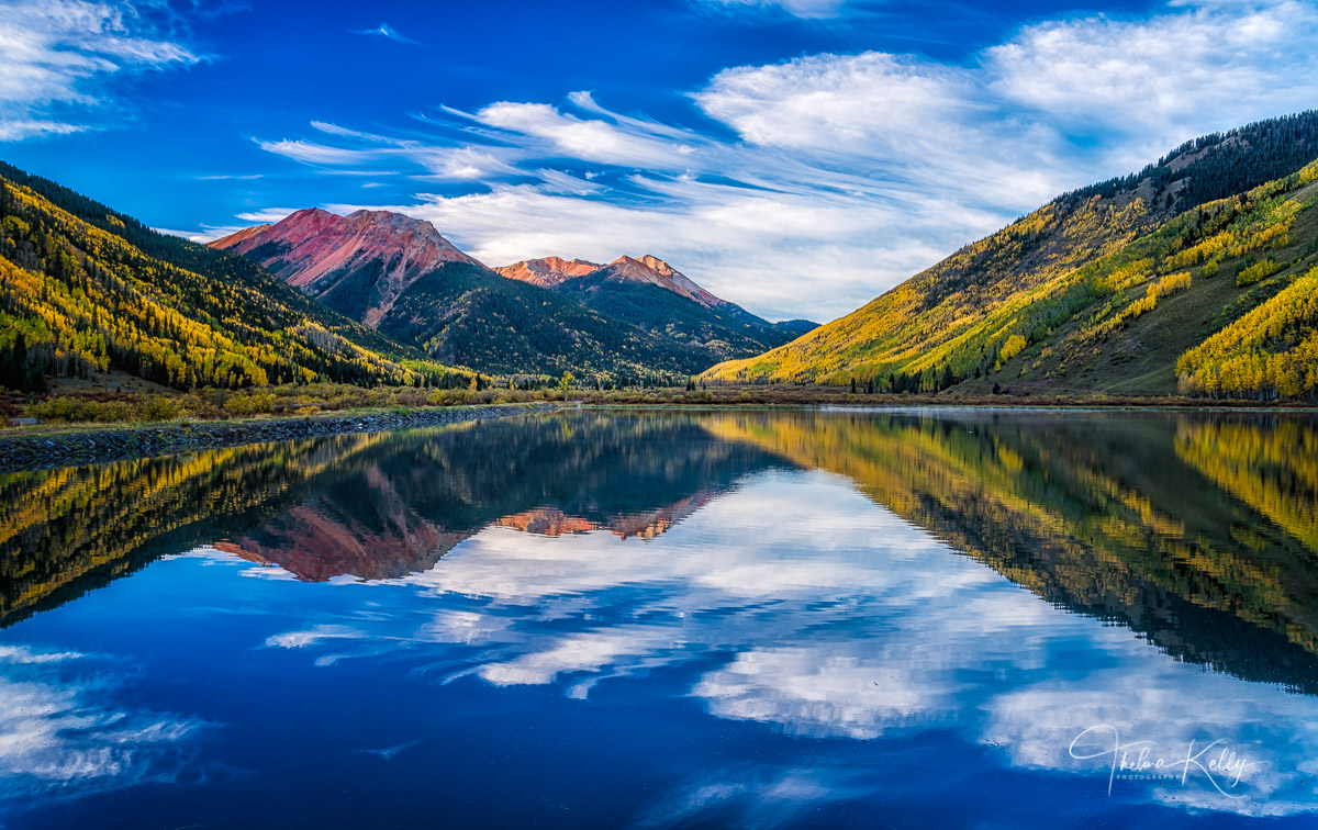 Reflection of clouds and fall color at Crystal Lake near Ouray in Colorado