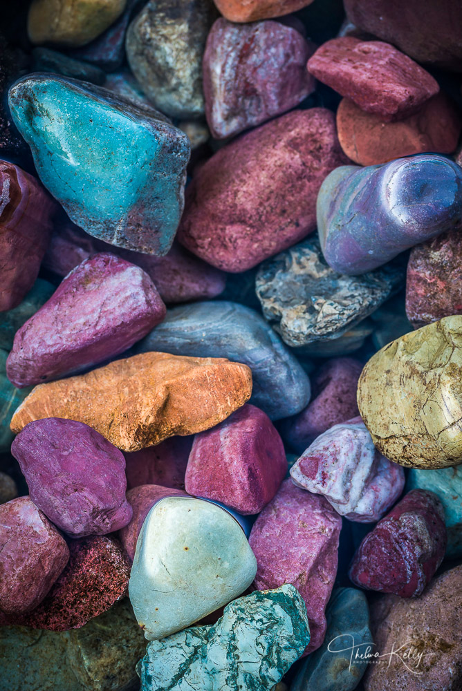 A multitude of colorful rocks blanket the shoreline at Lake MacDonald in Glacier National Park.